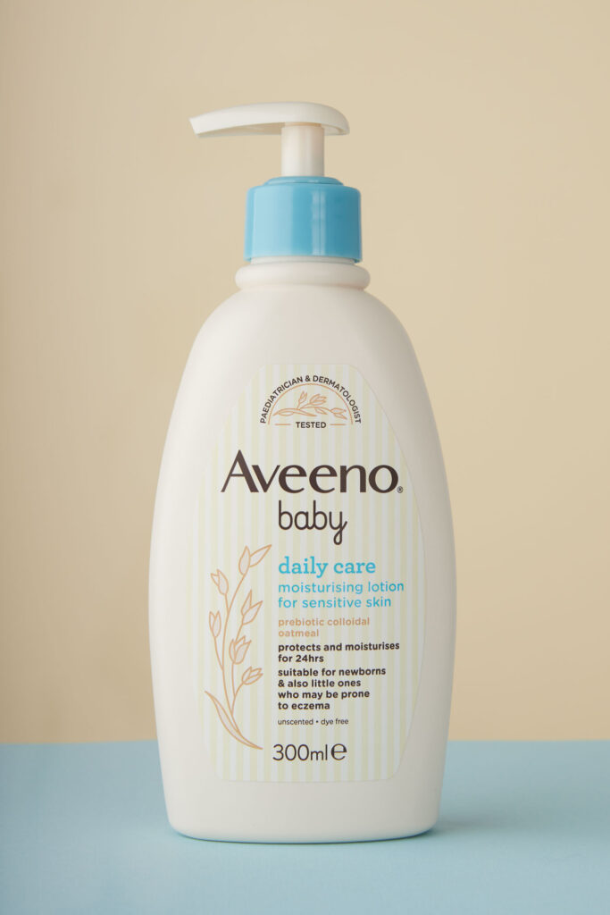 A product photography image for Amazon listing of a baby lotion on a pure white background